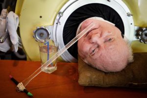 THE MAN WHO LIVES IN AN IRON LUNG.